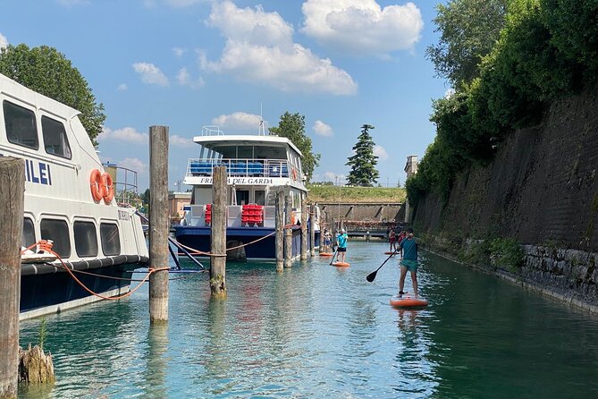 Sup experience with a ride to Peschiera del Garda Lake Garda - An aperitif along the main canal